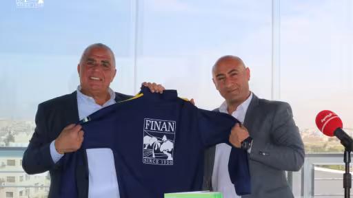 Finan Group and De La Salle Club representatives holding a team jersey at the MoU signing