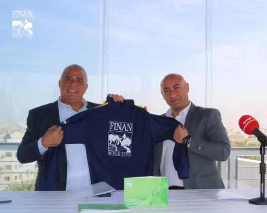 Finan Group and De La Salle Club representatives holding a team jersey at the MoU signing